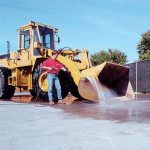 Man washing tractor with x-15 degreaser