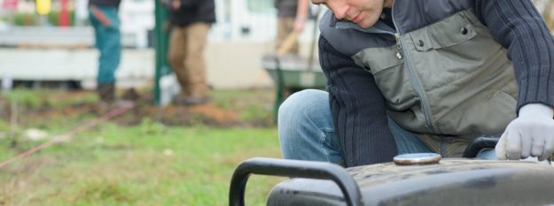 Builder turning on an air compressor Builder turning on an air compressor