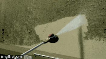Washing a box truck with a power washer.
