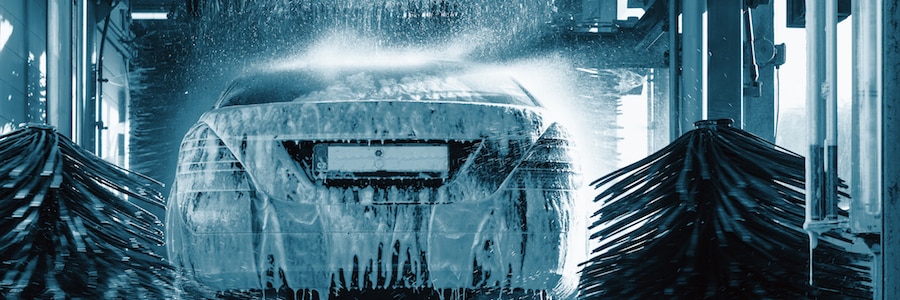 An automatic car wash rinses off the soap from a car using greywater recycled water.