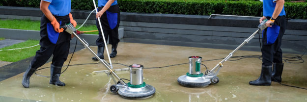 scrubber machine for cleaning and polishing floor Three men cleaning an exterior floor with floor scrubbers.