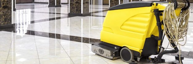 How-To-Maintain-Your-Floor-Scrubber Yellow floor cleaning machine on shiny marble tiles in a building lobby.